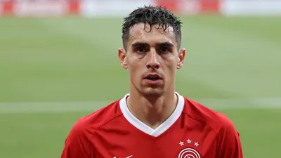Mid-30s Ajax midfielder, athletic build, intense expression, drenched in sweat, head-and-shoulders shot