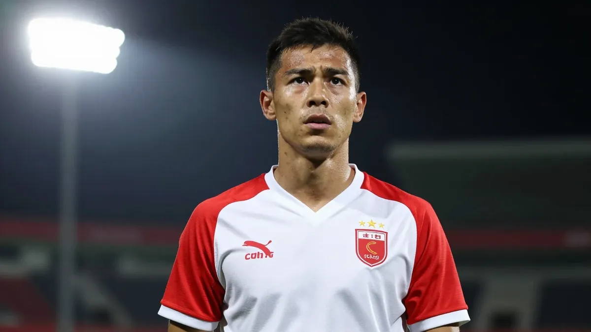 A 25-year-old male football player, wearing a red and white kit, with a determined expression, photographed with a 85mm...