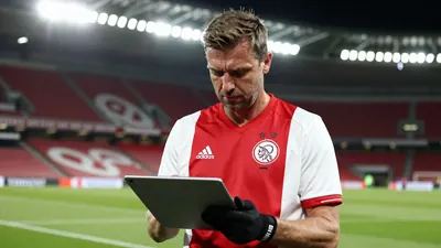 A 35-year-old AFC Ajax coach, a sturdy-built man with a weathered face, stands intensely on the Johan Cruijff Arena's...