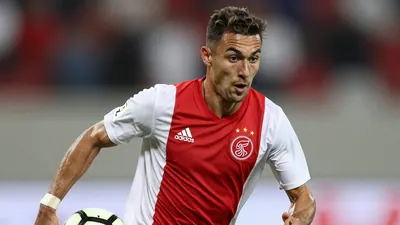 A photorealistic image of an anonymous Ajax player, aged 21-25, wearing a red and white jersey made of smooth fabric
